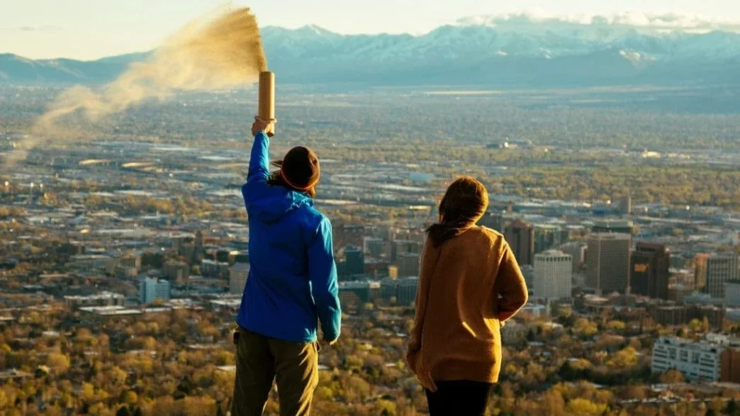 people spreading ashes from an urn