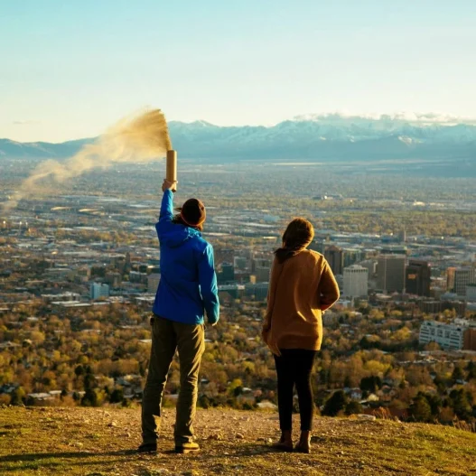 people spreading ashes from an urn