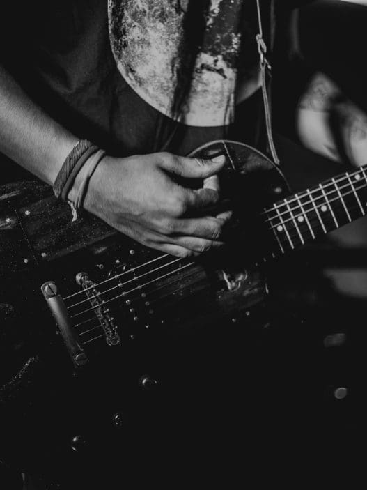 man holding and playing a guitar