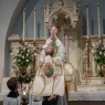 priest at Catholic funeral offering holy communion
