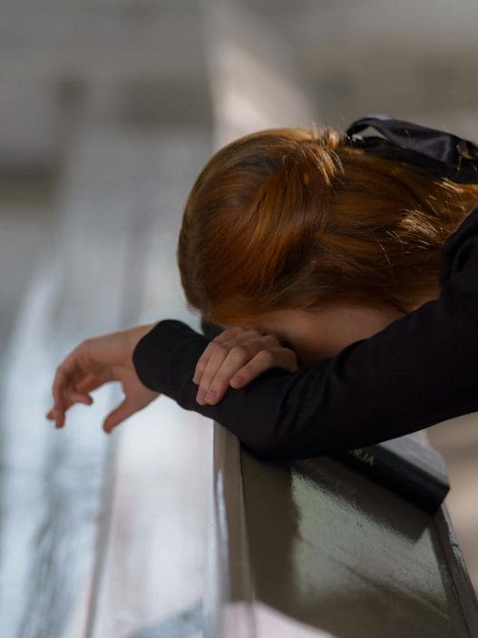 woman leaning on a bench