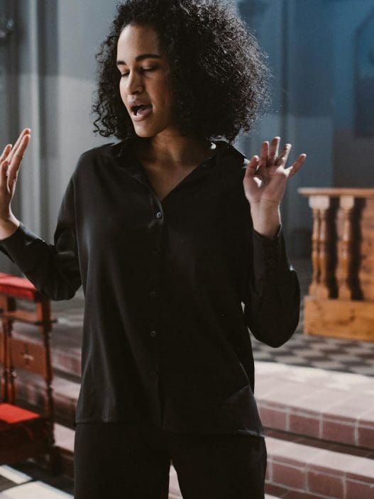 woman in black long sleeves standing near the altar
