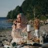 a woman wearing a hijab having a picnic at the beach