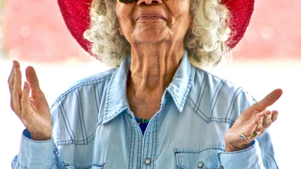 woman wearing red hat and sunglasses
