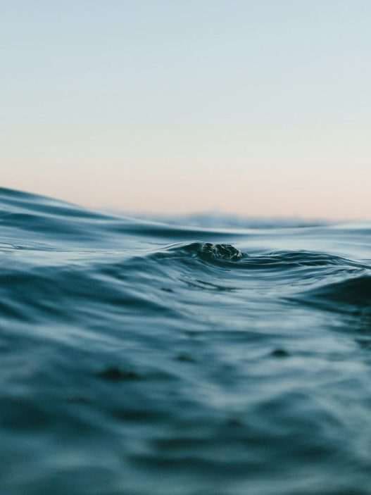body of water under blue and white skies