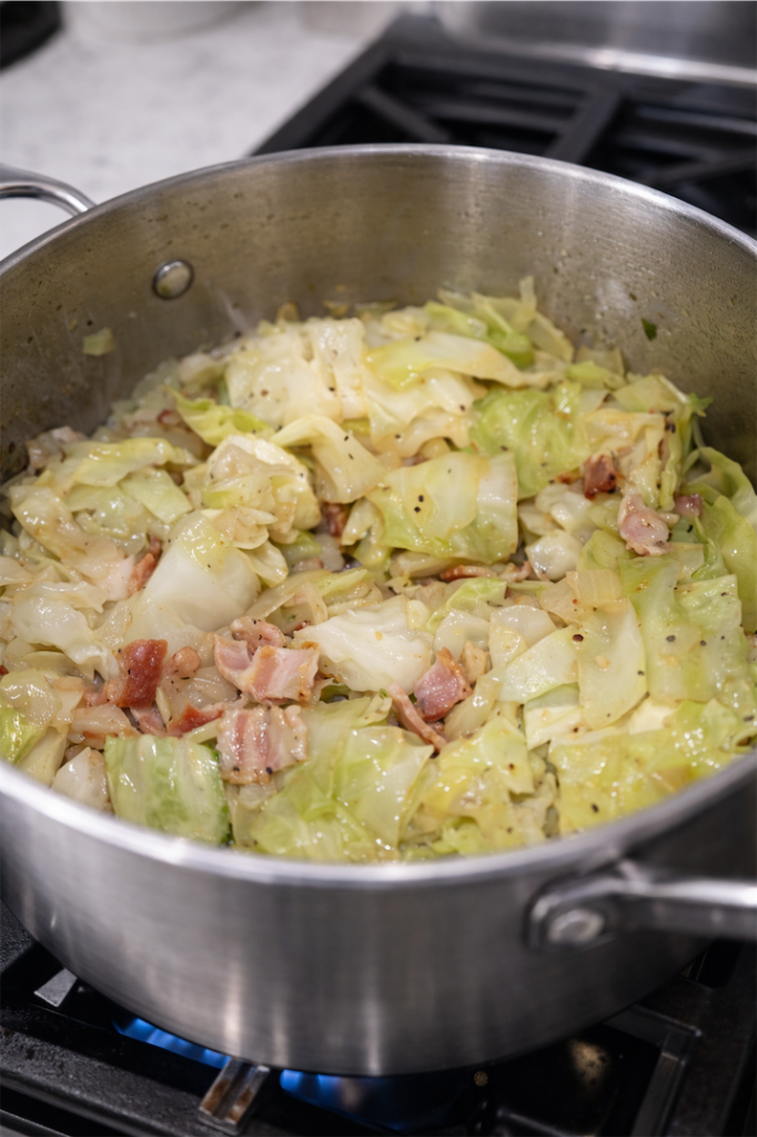 cabbage cooking in saucepan with bacon