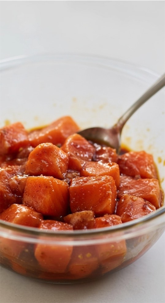 raw salmon bites in a glass bowl 