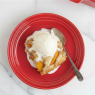 peach cobbler on red plate with icecream
