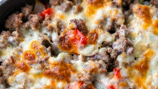 close up of baked beef cheesesteak casserole in skillet