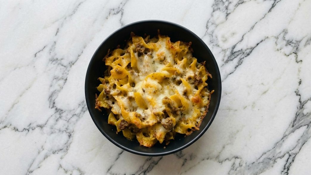 beef strog casserole in black bowl top down view