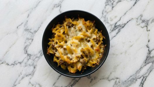 beef strog casserole in black bowl top down view