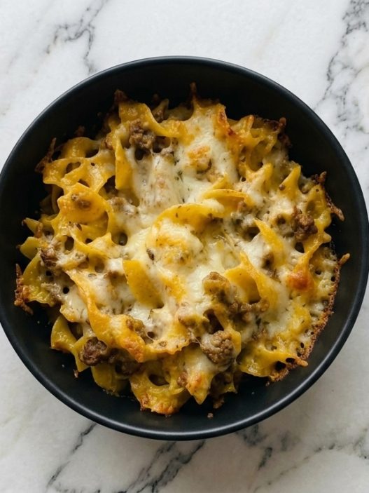 beef strog casserole in black bowl top down view
