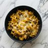 beef strog casserole in black bowl top down view